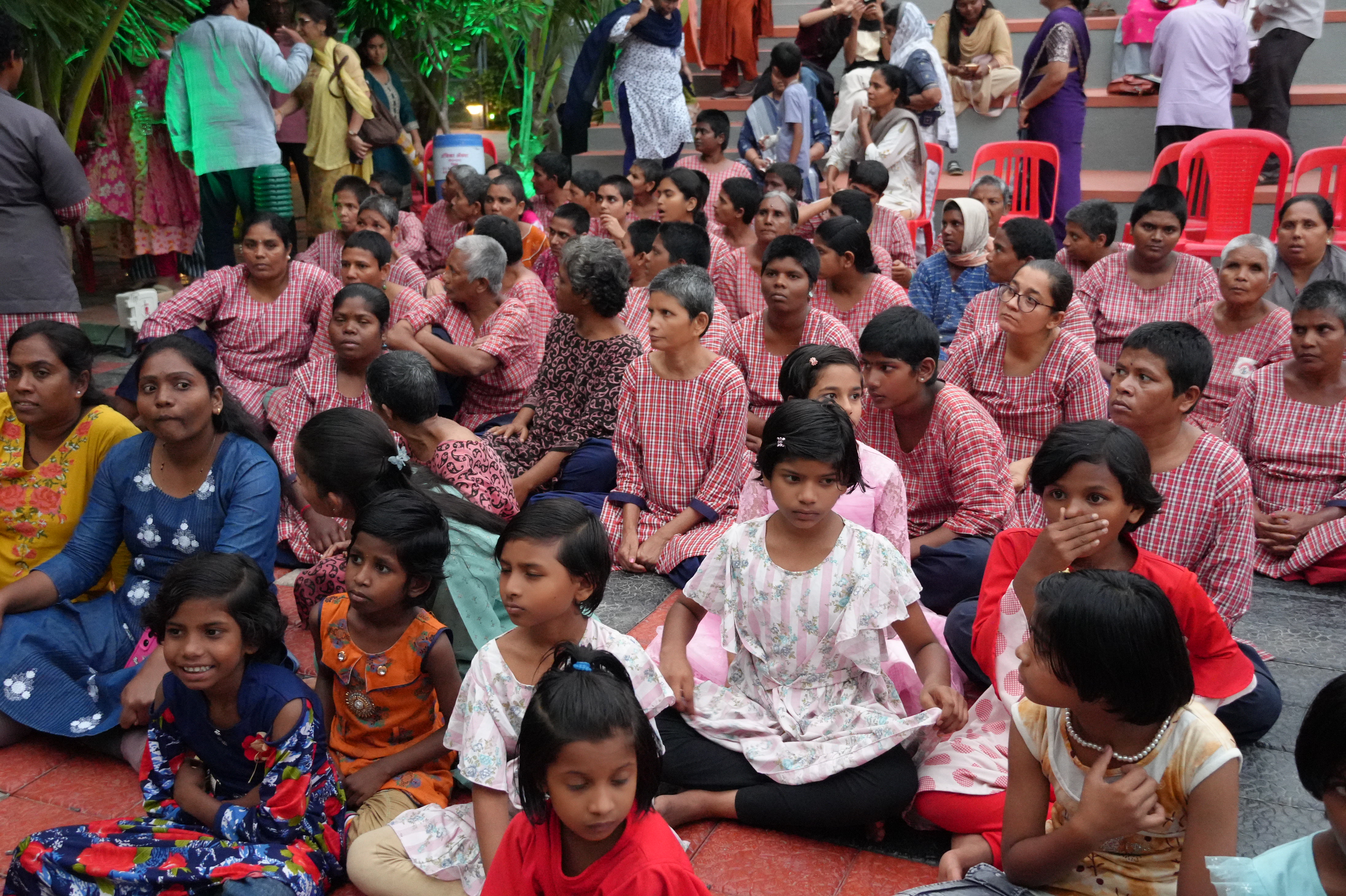 Audience members enjoying the open-air stage performance