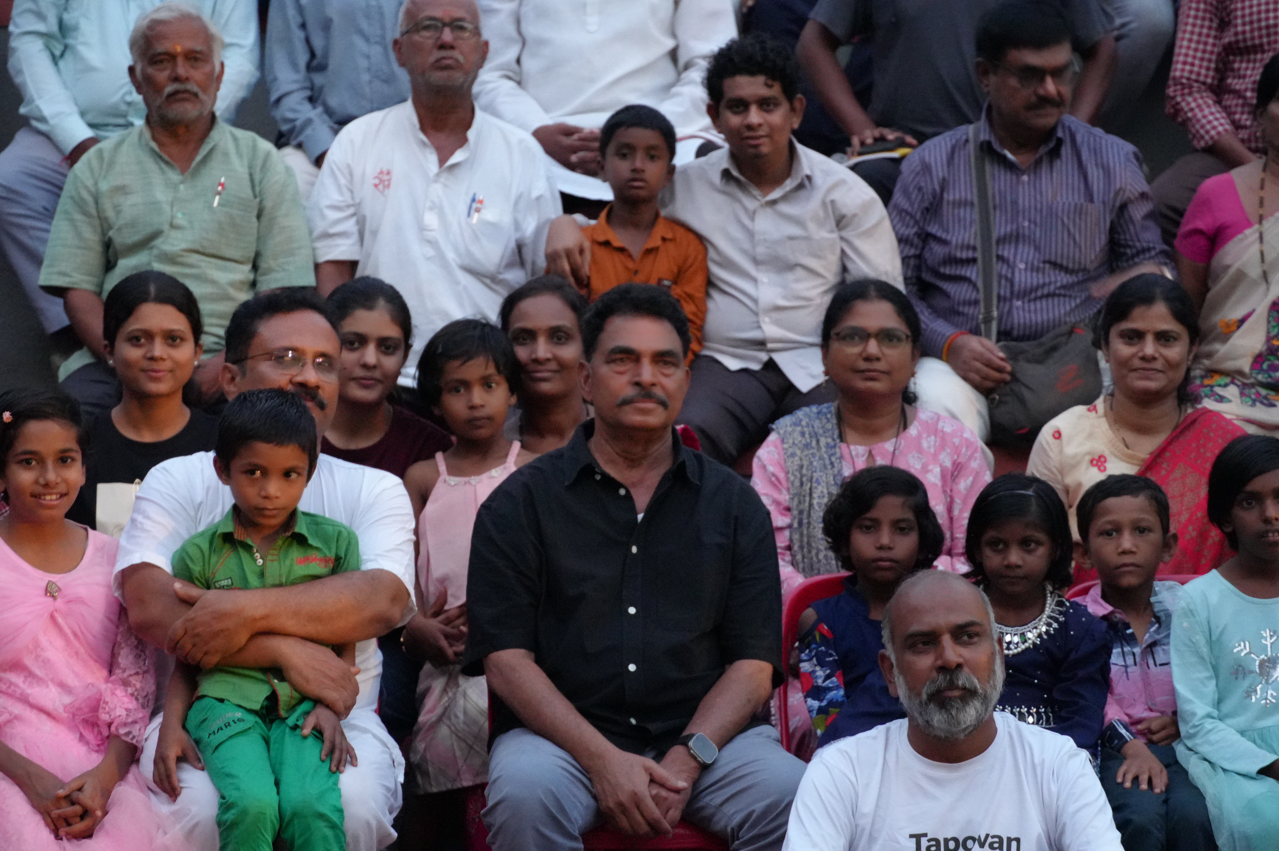 Large community gathering seated at amphitheater during Jhaad Sammelan